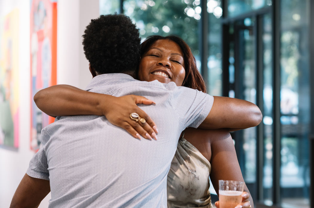 Warm embrace between two people at an event