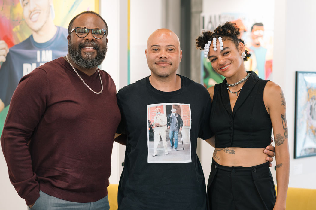 Three artists smiling at the camera