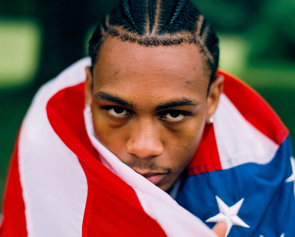 Black man wrapped in the American Flag